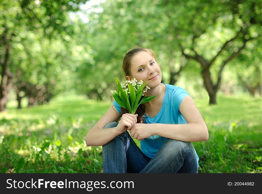 Young woman in the park with flowers. Young woman in the park with flowers