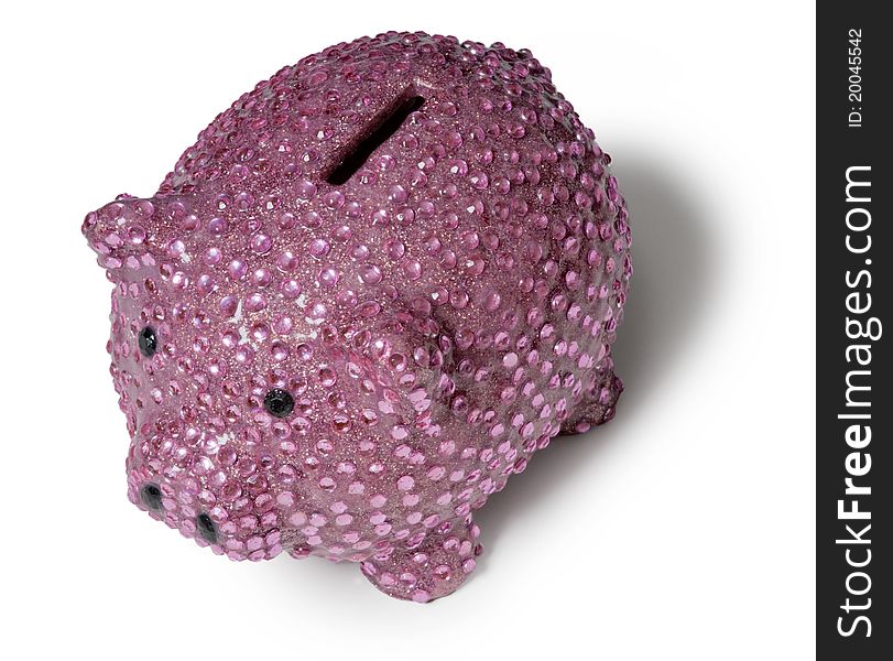 Shiny pink piggy bank with sequins isolated against a white background at an angle with shadow
