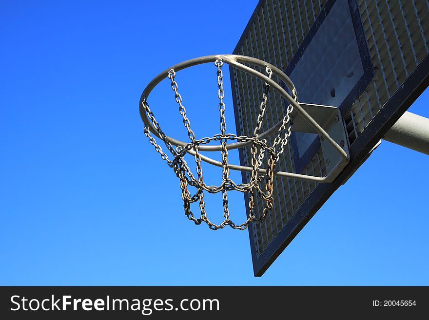 A basketball ring over a blue sky. A basketball ring over a blue sky