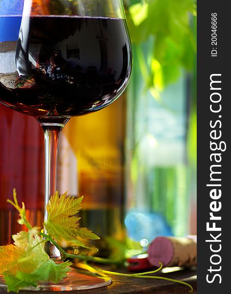 Bottle of red wine with glass and leaves. Bottle of red wine with glass and leaves.