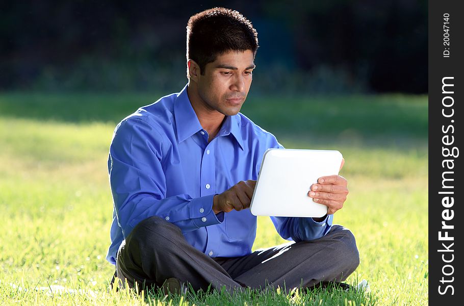 Businessman working with digital tablet at the park. Businessman working with digital tablet at the park