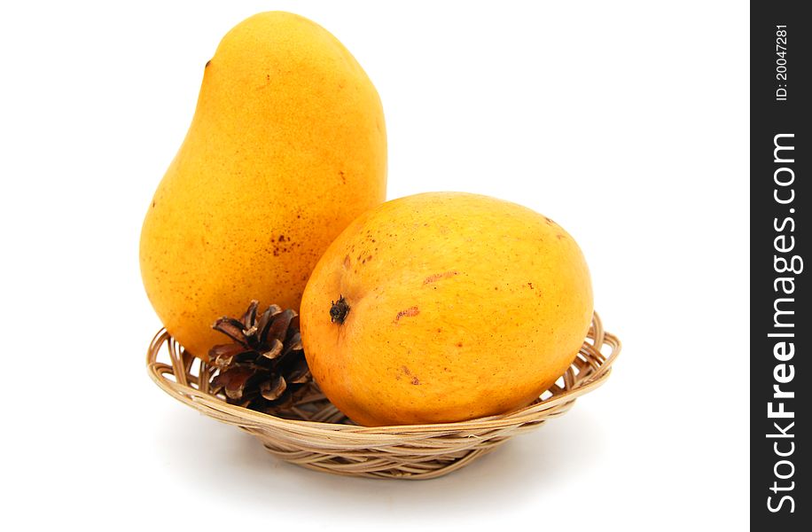 Ripe golden mangoes on white table