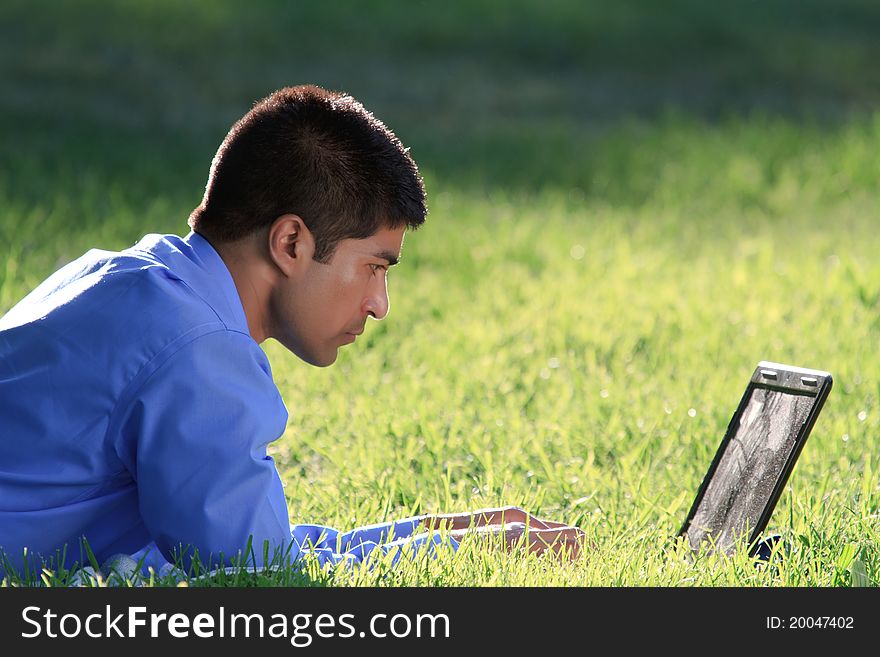 Young businessman working with laptop at the park. Young businessman working with laptop at the park