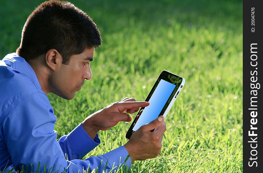 Businessman working with digital tablet at the park. Businessman working with digital tablet at the park