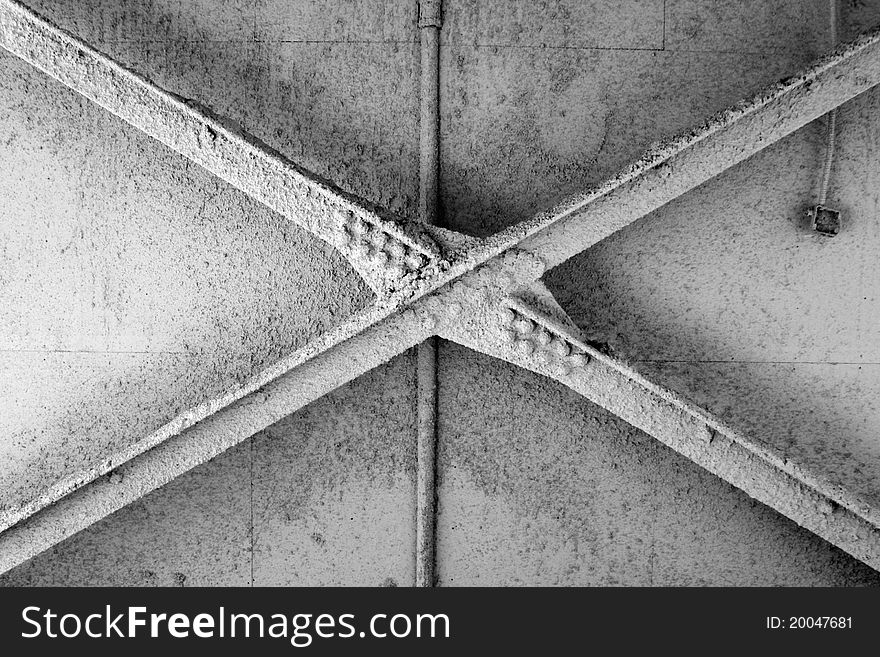 Abstract detail photo of industrial metal ceiling beams in empty warehouse