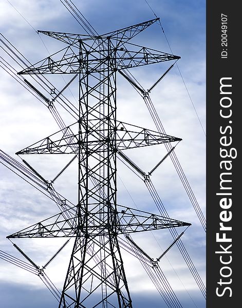 Electricity tower and power lines against the blue sky. Electricity tower and power lines against the blue sky