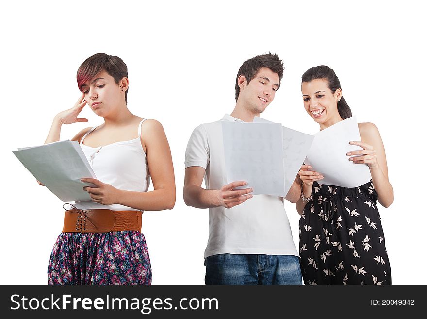 A man and two women studying some papers. A man and two women studying some papers