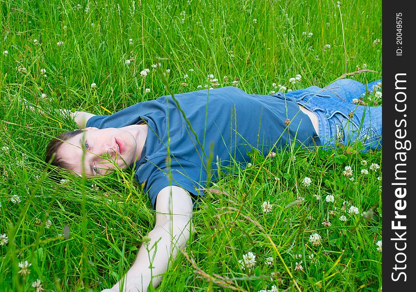 The Young Man Lies On A Green Grass