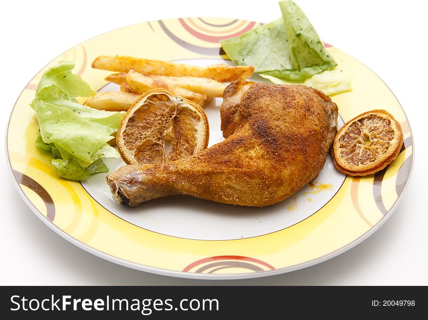 Roasted chicken thighs with Fries onto plates