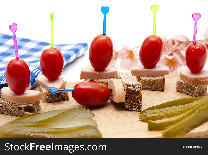 Tomato and sausage with bread on spit. Tomato and sausage with bread on spit