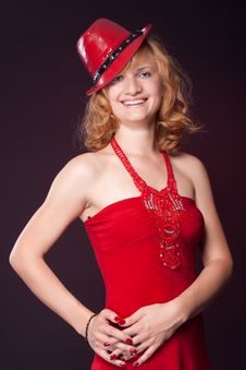 Red-haired Girl In A Red Dress And Red Hat Royalty Free Stock Photography Red-haired Girl In A Red Dress And Red Hat Royalty Free Stock Photography