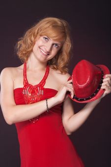 Red-haired Girl In A Red Dress And Red Hat Royalty Free Stock Photography Red-haired Girl In A Red Dress And Red Hat Royalty Free Stock Photography