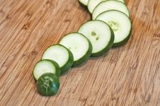 Sliced Cucumber Close Up On Cutting Board Wavy Stock Images