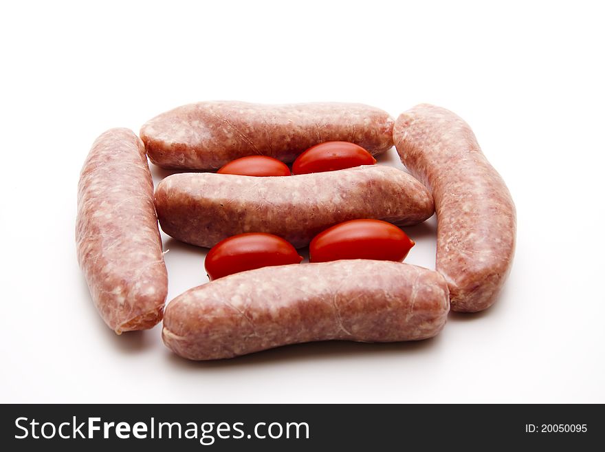 Coarse fried sausage with tomato onto white background