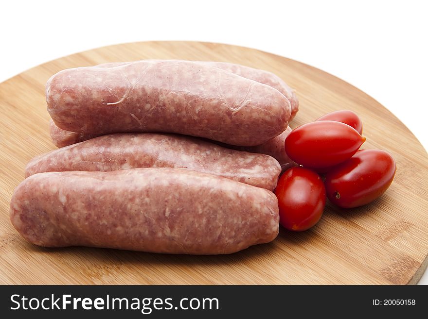 Coarse fried sausage with tomato onto wood plates