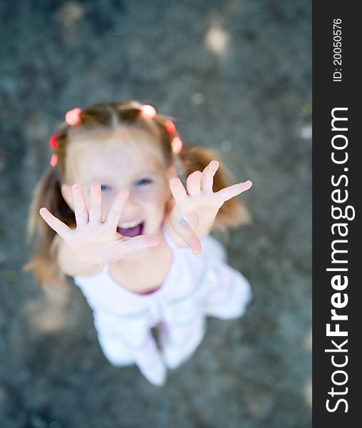 Cute little girl smiling in a park close-up