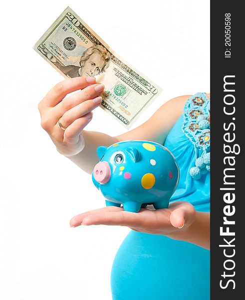 Pregnant woman with a piggy bank