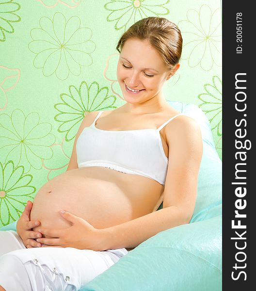 Lovely pregnant woman waiting for a child
