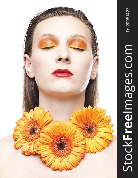 Young woman with colorful make-up and a orange gerbera flowers. Young woman with colorful make-up and a orange gerbera flowers.