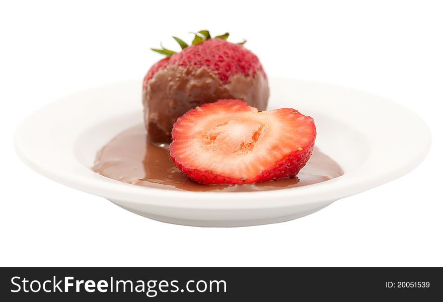 Strawberries in chocolate glaze on the plate