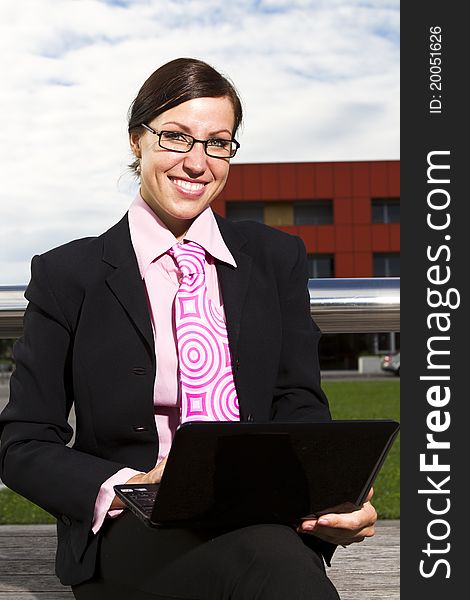 Pretty young woman manager in a neck tie outdoor shot