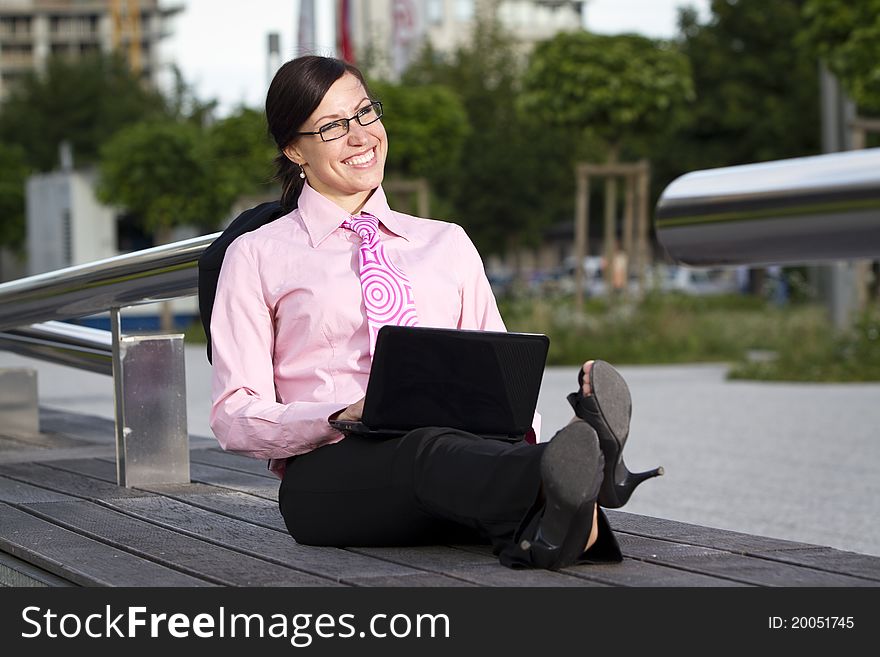 Pretty young woman manager in a neck tie outdoor shot
