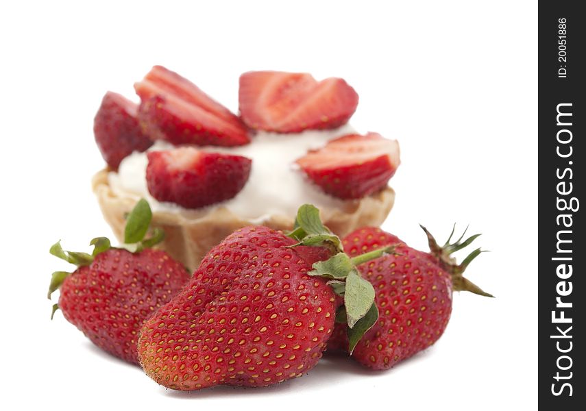 Strawberries and cream in a basket on a white background