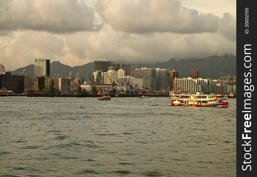 The view of Hong Kong Victoria Harbour with star ferry and modern buildings