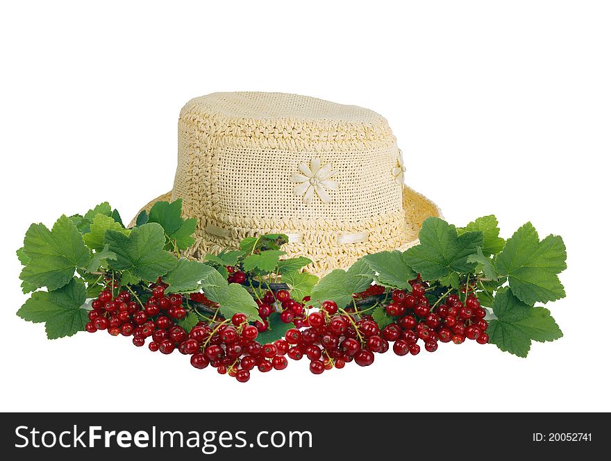 Summer female hat and branches of a red currant.