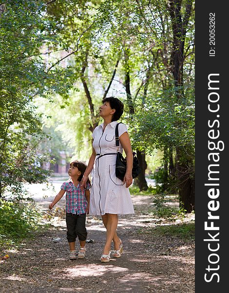 Grandmother and granddaughter walking in the park