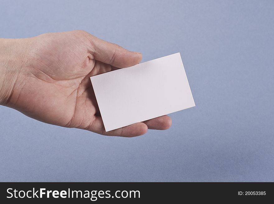Blank business card in elegant male hand on blue background Isolated. Blank business card in elegant male hand on blue background Isolated.