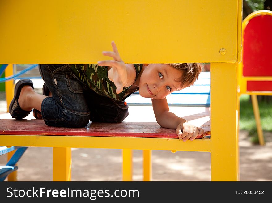Cute young boy playing on playground. Cute young boy playing on playground