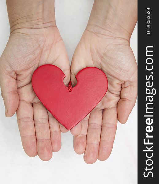 Two female hands offering a loving heart. Two female hands offering a loving heart.