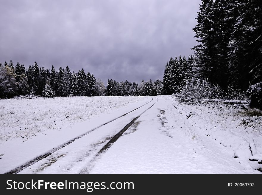 A snow covered dirt road in the winter. A snow covered dirt road in the winter