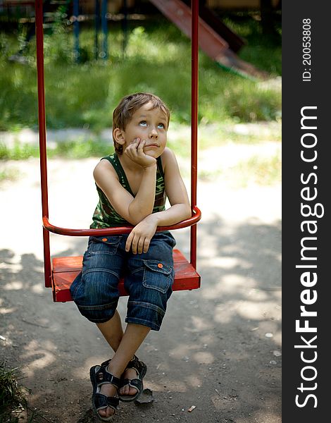 Little boy swinging on a swing. Little boy swinging on a swing