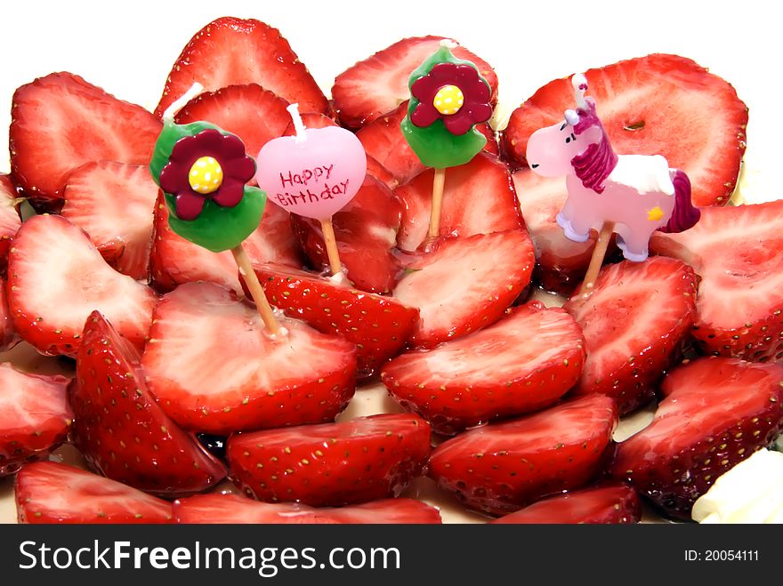 Four childish candles on a strawberry birthday cake, nobody, isolated over white, brightly lit, copyspace, copy space. Four childish candles on a strawberry birthday cake, nobody, isolated over white, brightly lit, copyspace, copy space