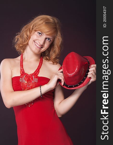 Red-haired girl in a red dress and red hat