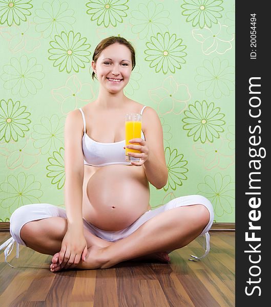 Beautiful pregnant young woman with pretty stomach holding an apple- isolated on white. Beautiful pregnant young woman with pretty stomach holding an apple- isolated on white