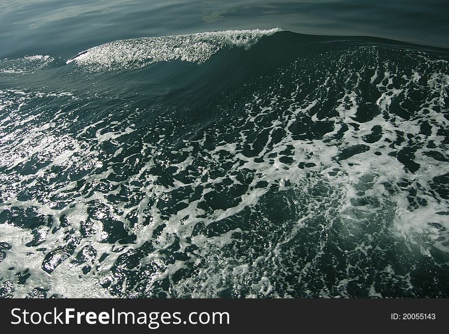 Big marine wave glittering with white bubbles. Big marine wave glittering with white bubbles