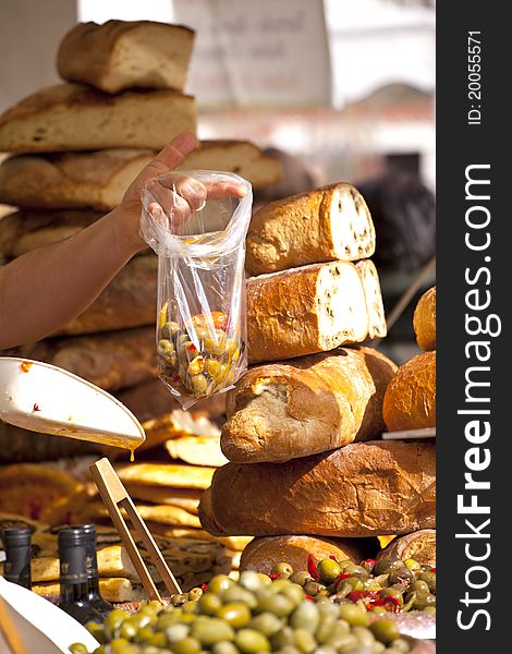 Green olives with bread background in a street market