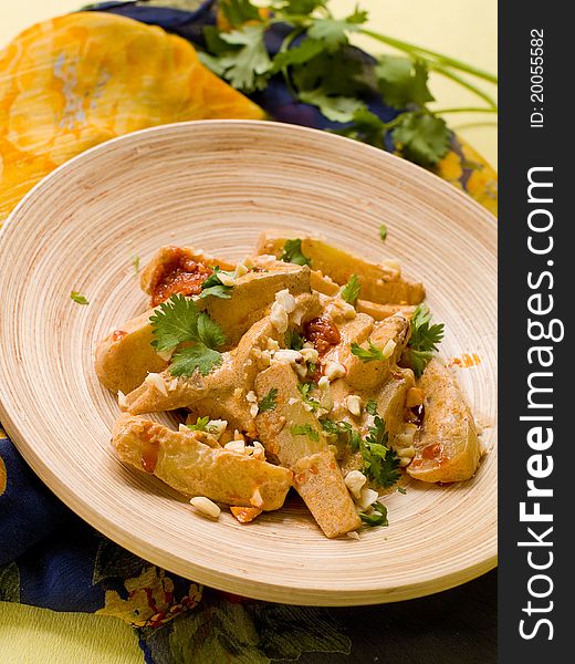 Bowl of spicy curry with vegetables and nut. Selective focus; shallow depth of field.