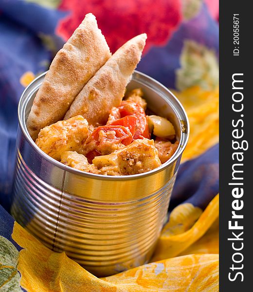 Bowl of spicy curry with cheese and vegetables.  Selective focus; shallow depth of field.