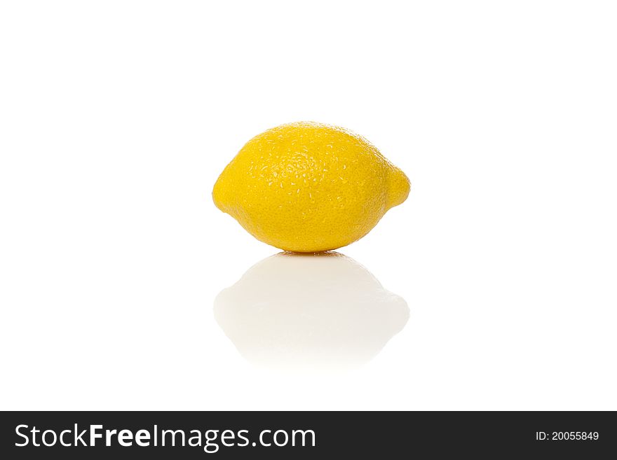 A fresh yellow lemon against a white background