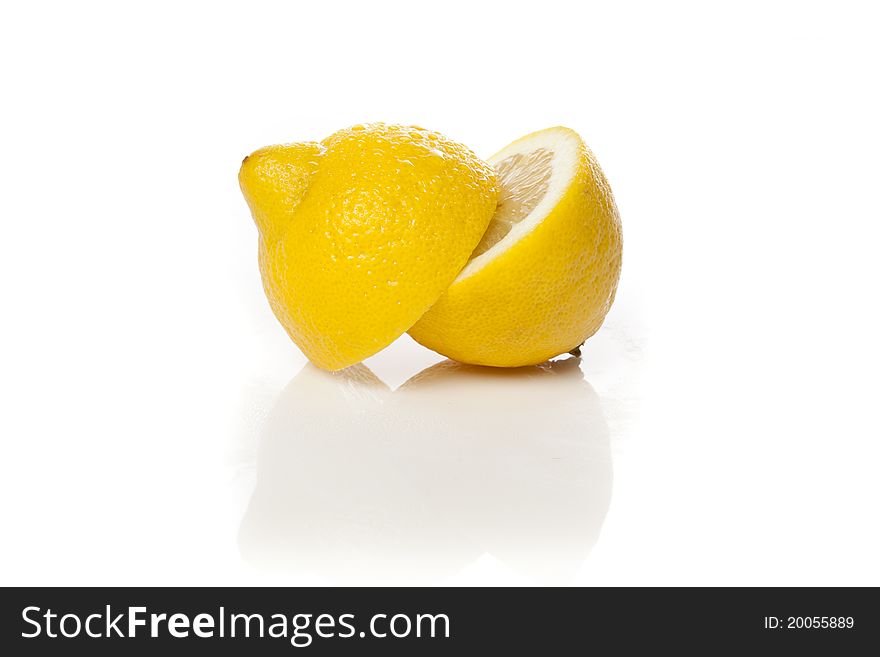 A fresh yellow lemon against a white background