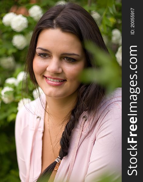 Young lady with plait in garden. Young lady with plait in garden