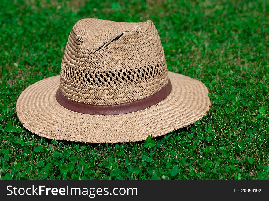 Old straw hat on grass