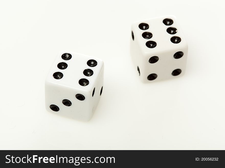 White dice with black dots against a white background