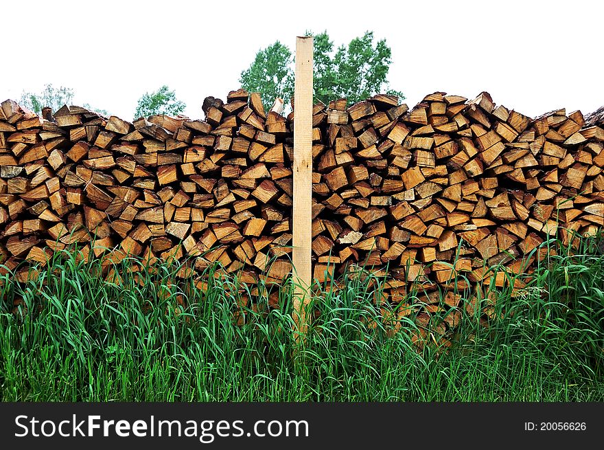 Background with yellow wood logs and green grass
