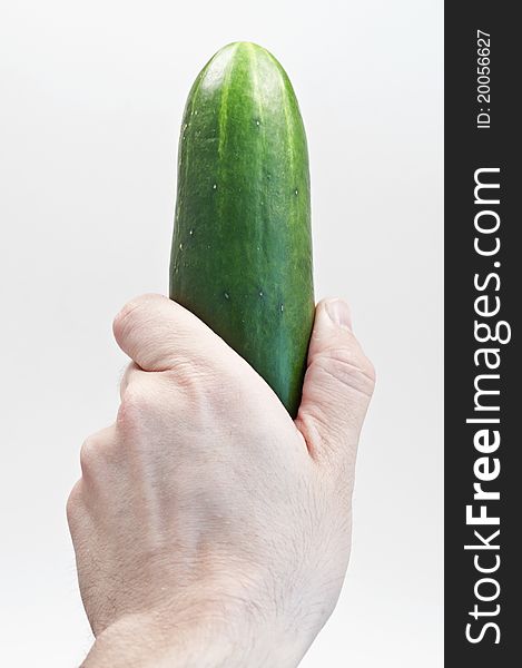 Cucumber held vertically on isolated white background