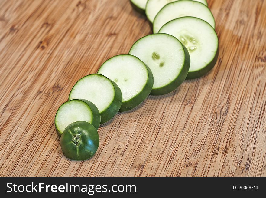 Sliced cucumber close up on cutting board wavy in line